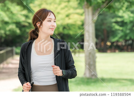 Young Asian woman strolling, walking and running in the park (aerobic exercise, dieting, fat burning) 119388504