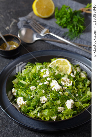 Classic Greek green lettuce salad with feta cheese 119389940