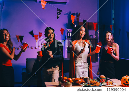 Joyful office Halloween party with coworkers in costumes, celebrating with drinks and laughter, fostering teamwork and festive spirit 119390904