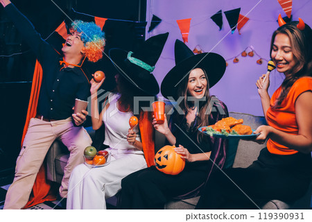 Joyful office Halloween party with coworkers in costumes, celebrating with drinks and laughter, fostering teamwork and festive spirit 119390931