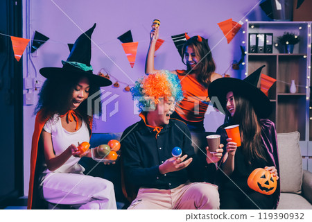 Joyful office Halloween party with coworkers in costumes, celebrating with drinks and laughter, fostering teamwork and festive spirit 119390932