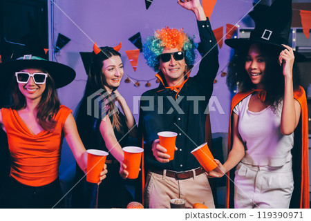 Joyful office Halloween party with coworkers in costumes, celebrating with drinks and laughter, fostering teamwork and festive spirit Joyful office Halloween party with coworkers in costumes, celebrating with drinks and laughter, fostering teamwork and festive spirit 119390971