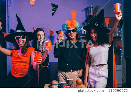 Joyful office Halloween party with coworkers in costumes, celebrating with drinks and laughter, fostering teamwork and festive spirit Joyful office Halloween party with coworkers in costumes, celebrating with drinks and laughter, fostering teamwork and festive spirit 119390972