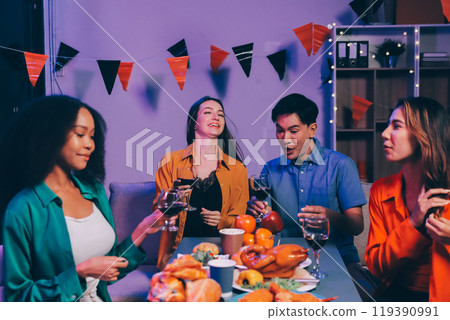 Joyful office Halloween party with coworkers in costumes, celebrating with drinks and laughter, fostering teamwork and festive spirit 119390991