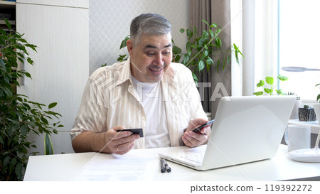 Man Entering Credit Card Information on Smartphone and Celebrating Unexpected Luck Man Entering Credit Card Information on Smartphone and Celebrating Unexpected Luck 119392272