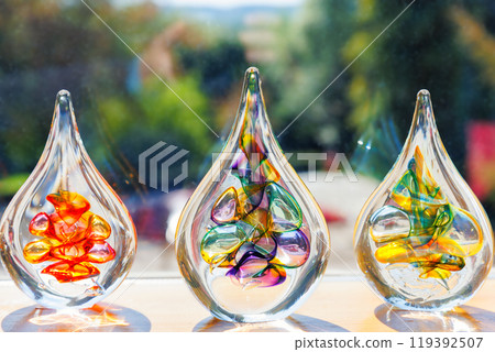 Colorful glass art sculptures displayed in sunlight Colorful glass art sculptures displayed in sunlight 119392507