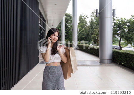 Stylish Woman Enjoying a Shopping Spree at the Mall with Paper Bags in Hand, Embracing Modern Retail Experience 119393210