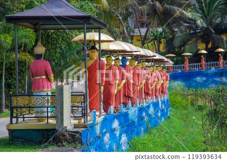 row of Buddhist monk statues in Dambulla row of Buddhist monk statues in Dambulla 119393634