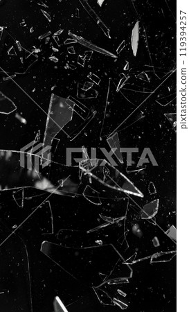 Close-up of shattering glass on black background , freeze motion 119394257