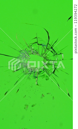Close-up of gunshot through the glass, shattering against the green background 119394272