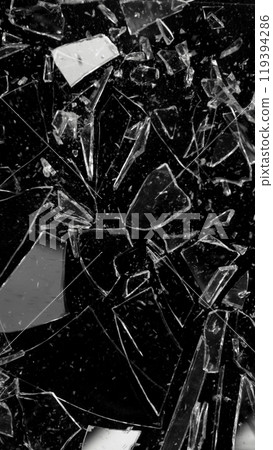Close-up of shattering glass on black background , freeze motion 119394286