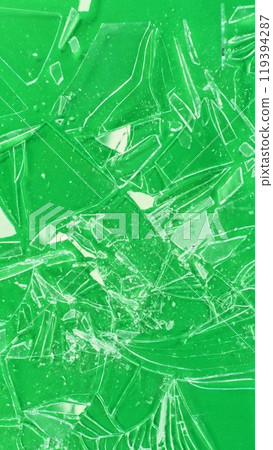 Close-up of shattering glass on green screen background , freeze motion 119394287
