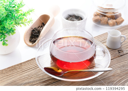 Enjoying black tea in a clear teacup (hot tea) 119394295