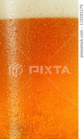 Closeup of beer bubbles in a glass. 119395279