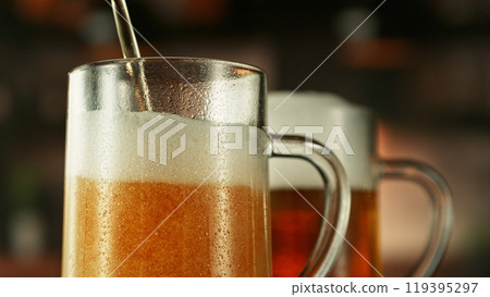 Pouring Beer into Long Glass. Closeup. 119395297