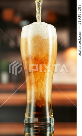 Pouring Beer into Long Glass, Vertical Composition. 119395298