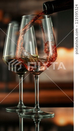 Pouring red wine from bottle. 119395324