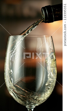 Detail of pouring white wine from bottle. Detail of pouring white wine from bottle. 119395351