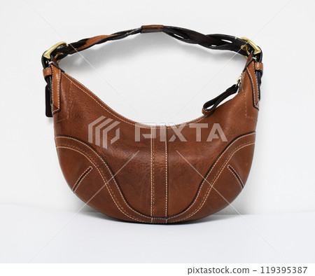 Vintage brown leather hobo bag on white background Vintage brown leather hobo bag on white background 119395387