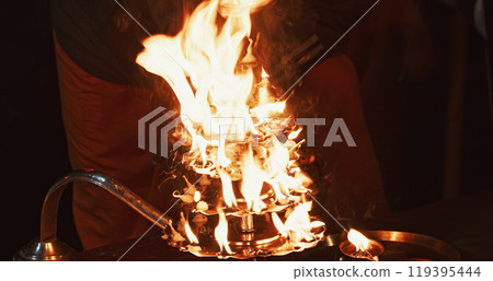 Varanasi, Uttar Pradesh, India. Candle Holder With Lit Candles On Ganga Maha Aarti Ceremony Begins. Fire Puja Ritual In Varanasi. Traditional Ganga Aarti At Ghat 119395444