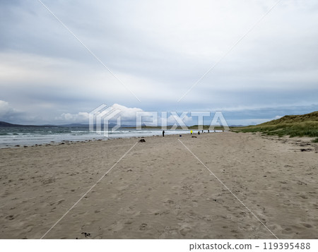20 man are competing in a fishing competition on the beach. 119395488