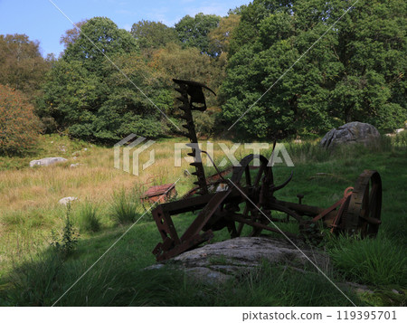 Old iron scrap in a forest near Egersund, Norway. Old iron scrap in a forest near Egersund, Norway. 119395701