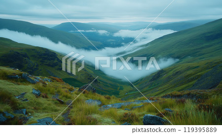 Foggy green mountain landscape with clouds rolling over hills. 119395889