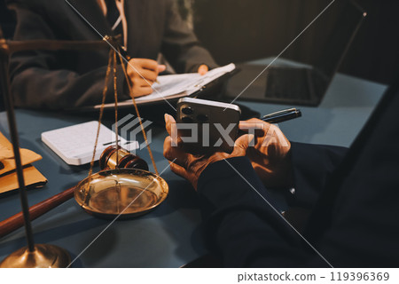 Judge gavel with Justice lawyers having team meeting at law firm background. Concepts of Law and Legal services. 119396369