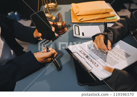 Judge gavel with Justice lawyers having team meeting at law firm background. Concepts of Law and Legal services. 119396370