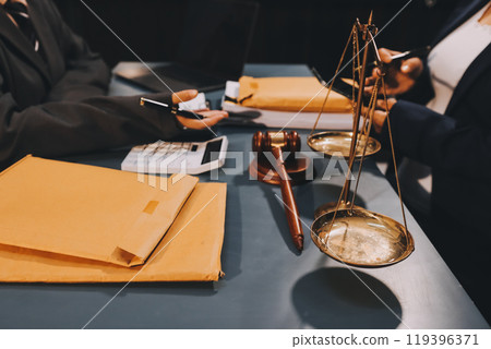Judge gavel with Justice lawyers having team meeting at law firm background. Concepts of Law and Legal services. Judge gavel with Justice lawyers having team meeting at law firm background. Concepts of Law and Legal services. 119396371