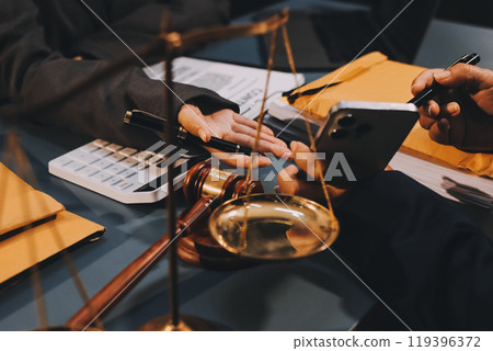Judge gavel with Justice lawyers having team meeting at law firm background. Concepts of Law and Legal services. Judge gavel with Justice lawyers having team meeting at law firm background. Concepts of Law and Legal services. 119396372