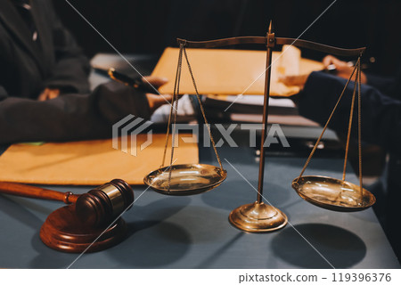 Judge gavel with Justice lawyers having team meeting at law firm background. Concepts of Law and Legal services. 119396376