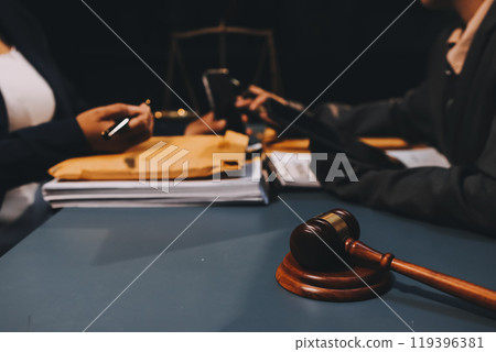 Judge gavel with Justice lawyers having team meeting at law firm background. Concepts of Law and Legal services. 119396381