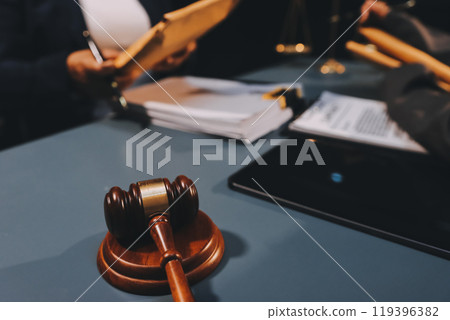 Judge gavel with Justice lawyers having team meeting at law firm background. Concepts of Law and Legal services. Judge gavel with Justice lawyers having team meeting at law firm background. Concepts of Law and Legal services. 119396382