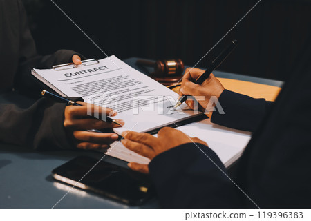 Judge gavel with Justice lawyers having team meeting at law firm background. Concepts of Law and Legal services. 119396383