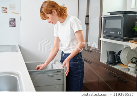 Woman opening cupboard, housewife, housework, cooking, cleaning up Woman opening cupboard, housewife, housework, cooking, cleaning up 119396535