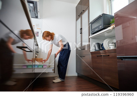 Woman opening cupboard, housewife, housework, cooking, cleaning up 119396960