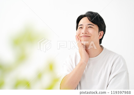 Man touching his cheek, smiling 119397988