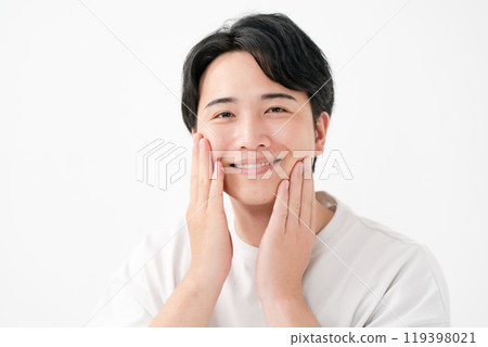 Man touching his cheek, smiling Man touching his cheek, smiling 119398021