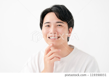 Man touching his cheek, smiling 119398031