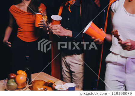 Joyful office Halloween party with coworkers in costumes, celebrating with drinks and laughter, fostering teamwork and festive spirit Joyful office Halloween party with coworkers in costumes, celebrating with drinks and laughter, fostering teamwork and festive spirit 119398079