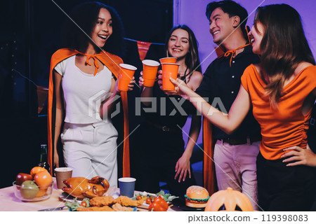 Joyful office Halloween party with coworkers in costumes, celebrating with drinks and laughter, fostering teamwork and festive spirit 119398083