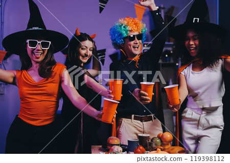 Joyful office Halloween party with coworkers in costumes, celebrating with drinks and laughter, fostering teamwork and festive spirit 119398112