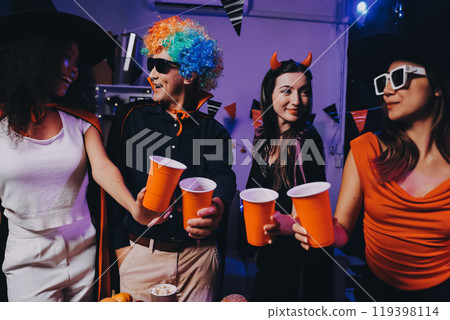 Joyful office Halloween party with coworkers in costumes, celebrating with drinks and laughter, fostering teamwork and festive spirit Joyful office Halloween party with coworkers in costumes, celebrating with drinks and laughter, fostering teamwork and festive spirit 119398114