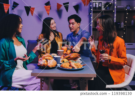 Joyful office Halloween party with coworkers in costumes, celebrating with drinks and laughter, fostering teamwork and festive spirit 119398130