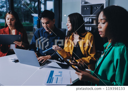 Young corporate employees sitting in office looking at laptop screen reading good news excited happy team diverse people celebrating victory win command success excellent result professional teamwork 119398133