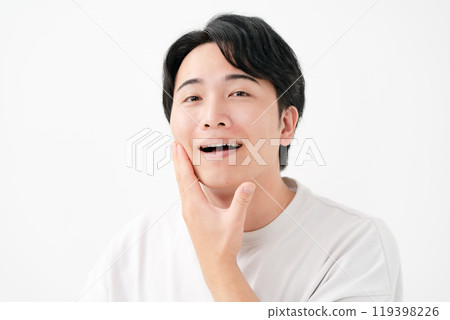 Man touching his cheek, smiling Man touching his cheek, smiling 119398226