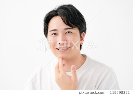 Man touching his cheek, smiling 119398231