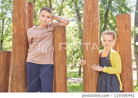 Children in playground. boy and girl enjoying a sunny day outdoors at a park Children in playground. boy and girl enjoying a sunny day outdoors at a park 119398442