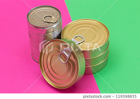 A Group of Stacked Tin Cans on Split Green and Cyan Background 119398655
